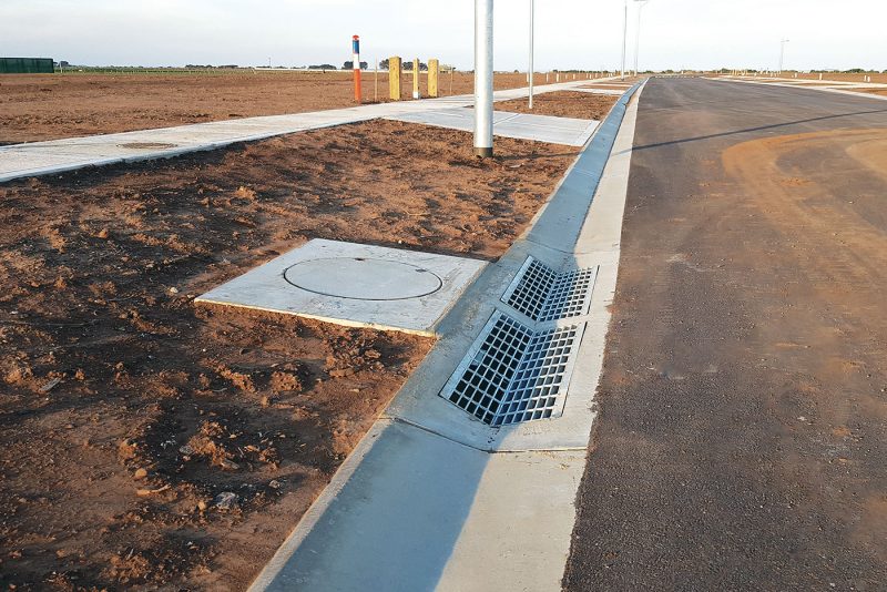 SVC encased and concrete access covers installed roadside.